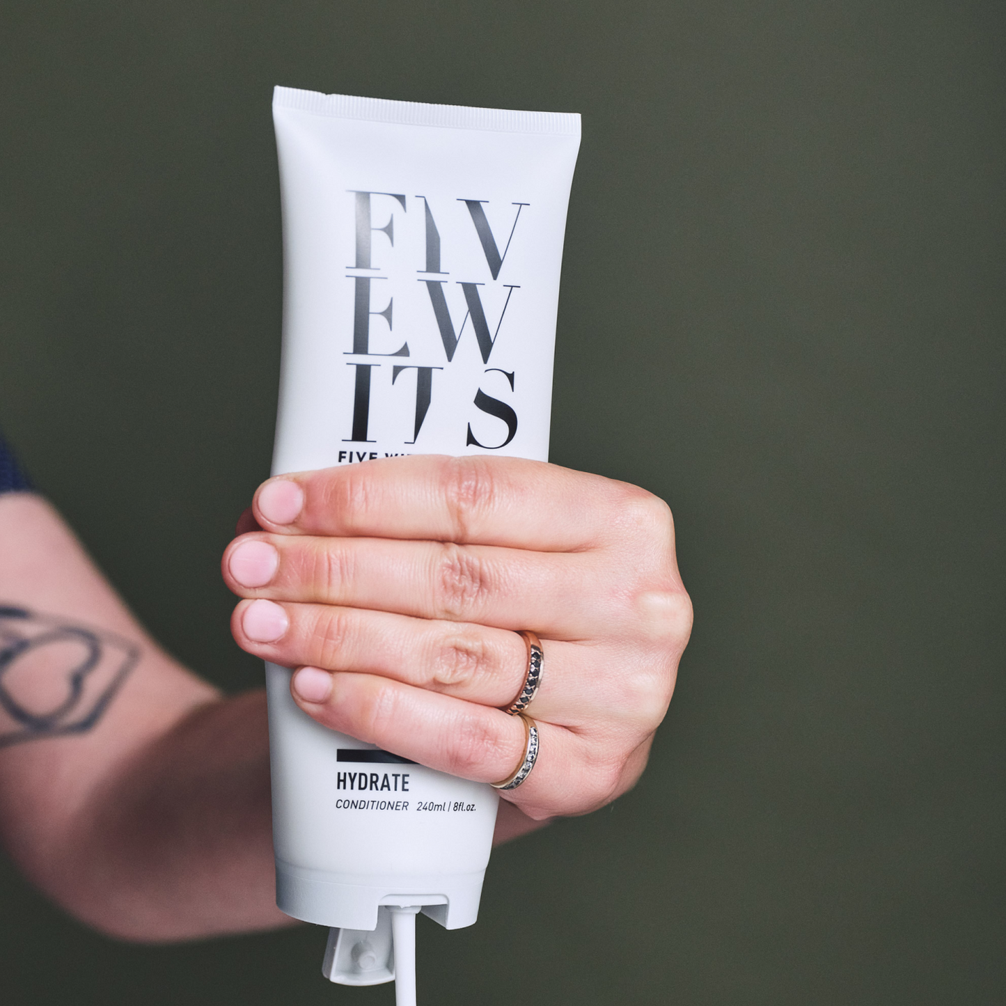 hand squeezing hydrate conditioner bottle
