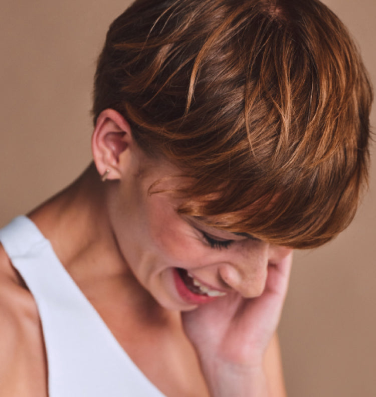 woman laughing w stylish short hair cut