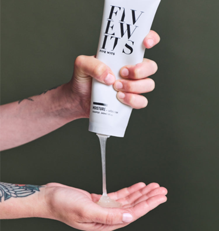 hand squeezing Five Wits mositure shampoo bottle