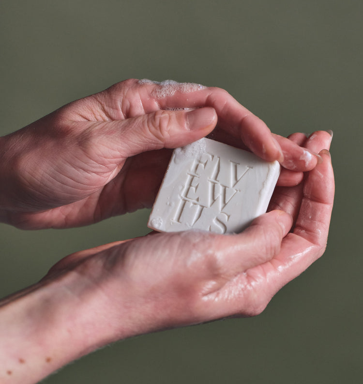hands holding five wits bar soap