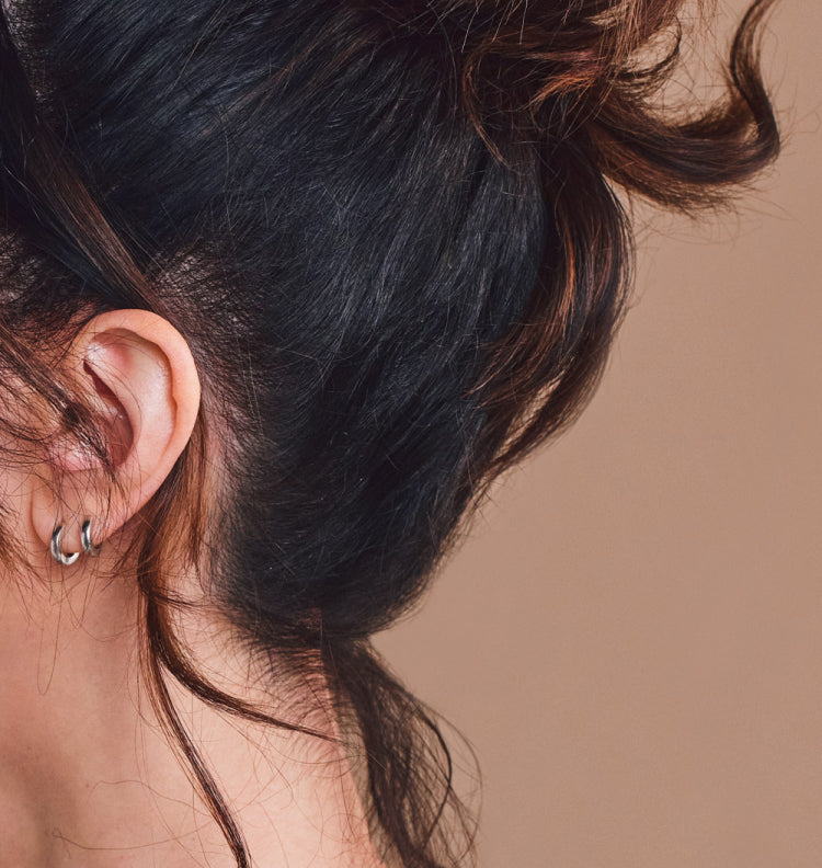 profile close up of woman with hair pulled up