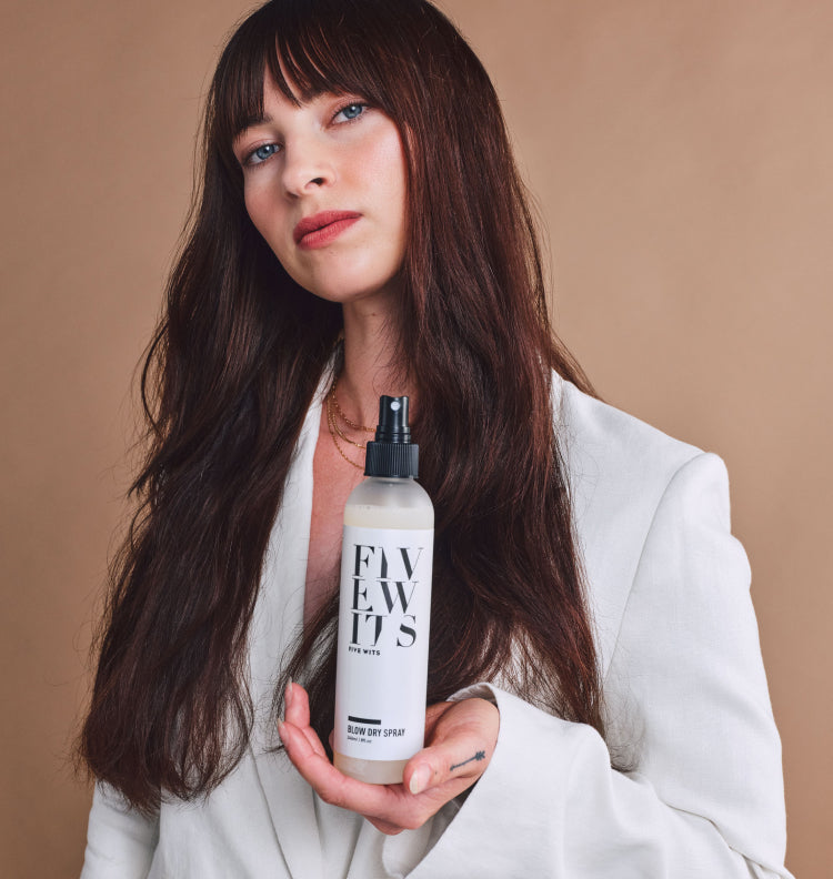 young woman holding Five Wits blow dry spray