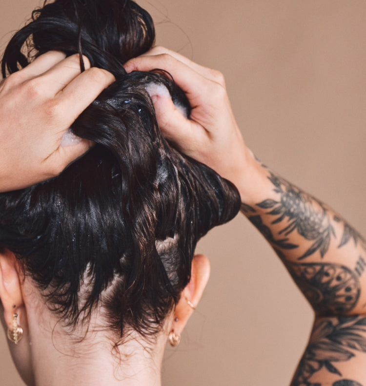 back of woman washing her hair